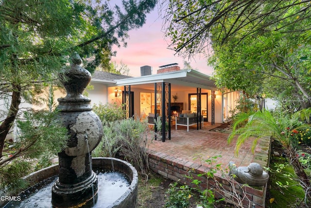 rear view of property featuring a patio