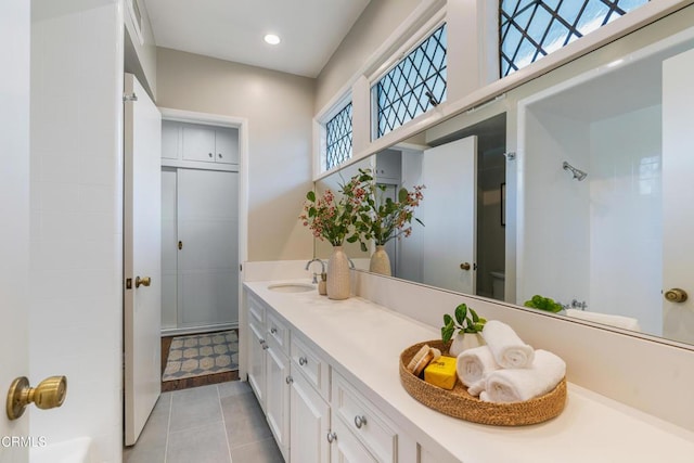 full bath featuring tile patterned floors, walk in shower, recessed lighting, and vanity