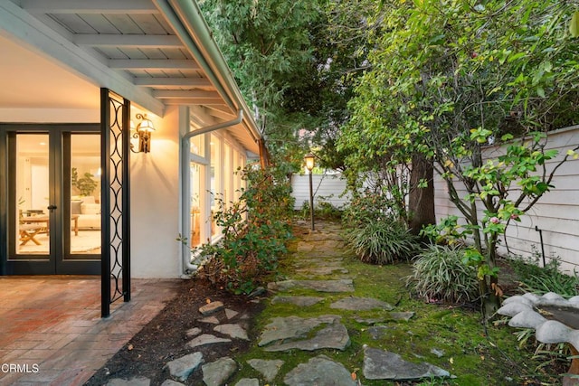 view of yard with a patio, french doors, and fence