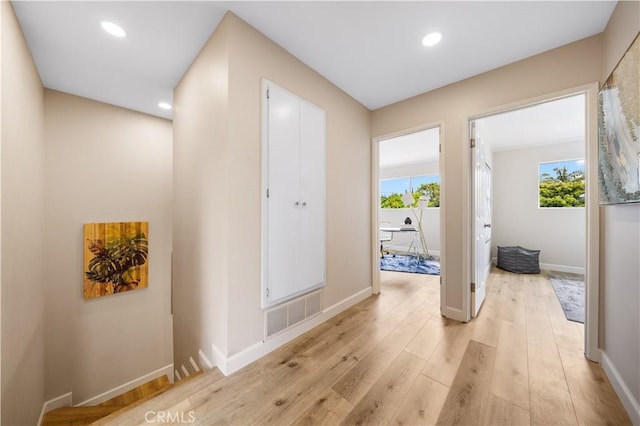 hall with visible vents, recessed lighting, light wood-style floors, and a healthy amount of sunlight