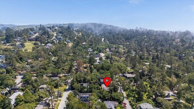 birds eye view of property with a mountain view and a wooded view