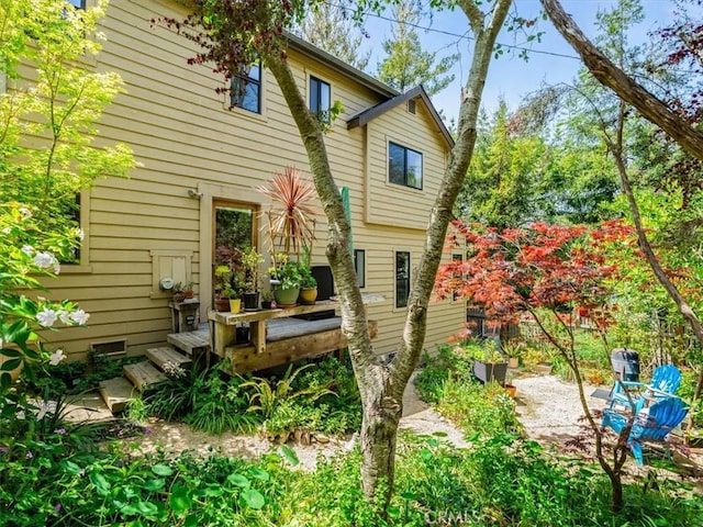 rear view of property with a wooden deck