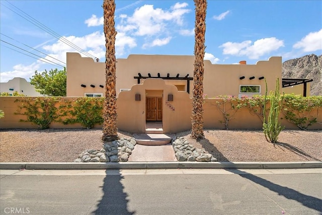 51770 Avenida Madero Ln, Quinta, CA 92253 - pueblo-style home featuring a fenced front yard and stucco siding
