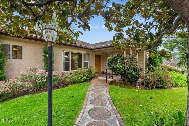 single story home with a front yard and stucco siding