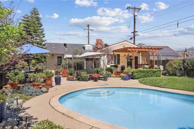 exterior space with an outdoor pool, stucco siding, a patio, and a pergola