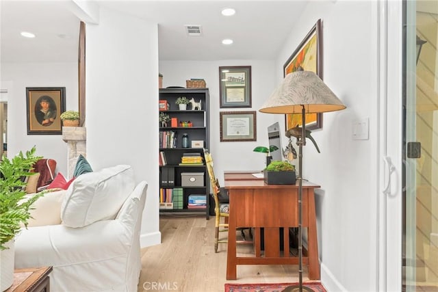 home office with light wood-style flooring, visible vents, and recessed lighting