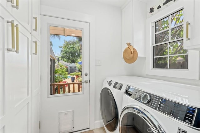 laundry room with cabinet space and washing machine and clothes dryer