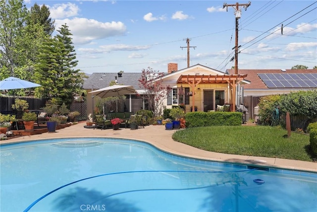 view of swimming pool featuring a pergola, a yard, a patio, fence, and a fenced in pool