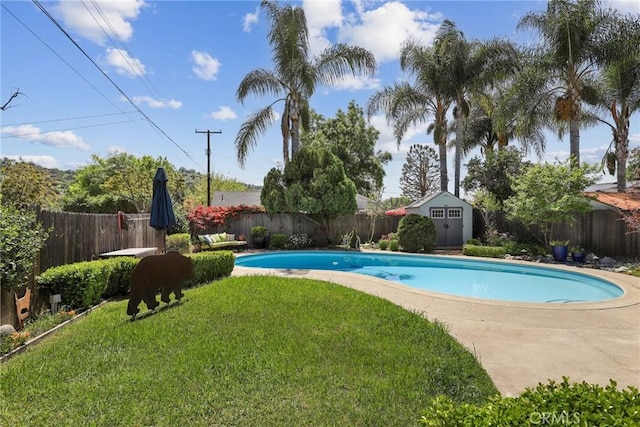 view of pool featuring a fenced in pool, a fenced backyard, a storage shed, an outbuilding, and a yard