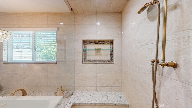 full bathroom featuring a tile shower and a bath