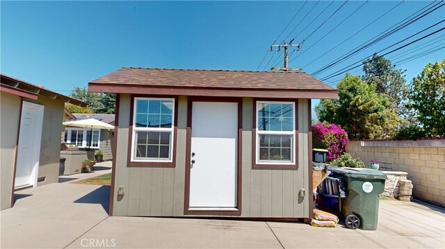 view of outbuilding with an outbuilding and fence