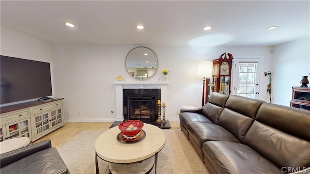 living area with recessed lighting, baseboards, and a premium fireplace