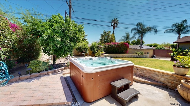 view of patio with fence and a hot tub