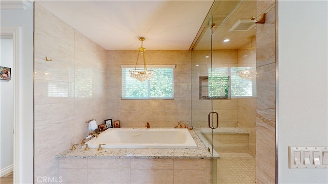 bathroom with a bath and a stall shower
