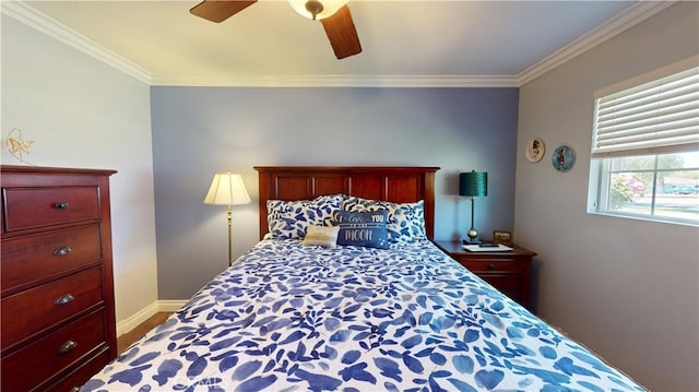 bedroom with wood finished floors, baseboards, crown molding, and ceiling fan