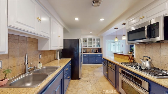 kitchen featuring a sink, appliances with stainless steel finishes, recessed lighting, white cabinetry, and blue cabinetry