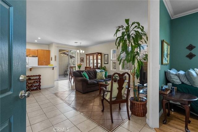 living room with baseboards, an inviting chandelier, recessed lighting, light tile patterned floors, and crown molding