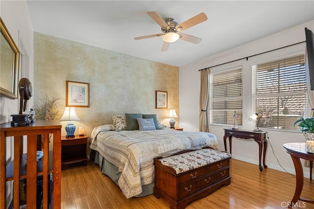 bedroom featuring baseboards and wood finished floors