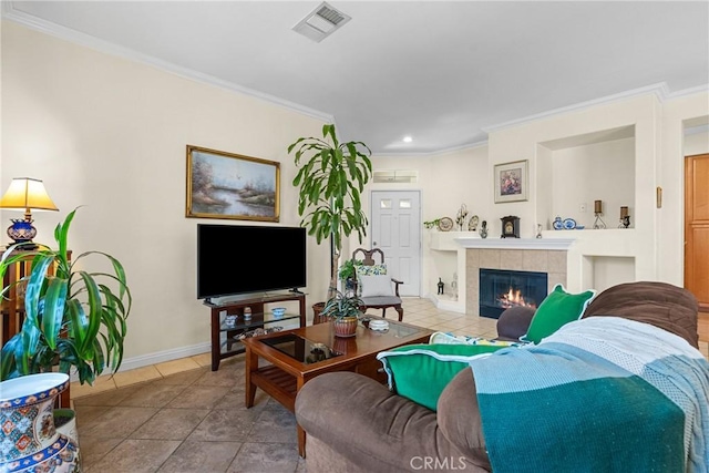 living area with a tiled fireplace, visible vents, baseboards, and ornamental molding