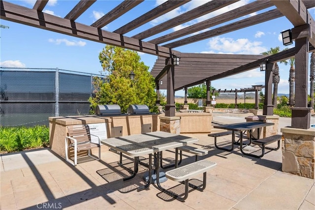 view of patio with grilling area, fence, area for grilling, and a pergola