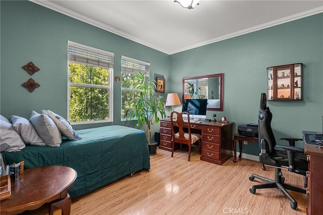bedroom with ornamental molding, baseboards, and wood finished floors