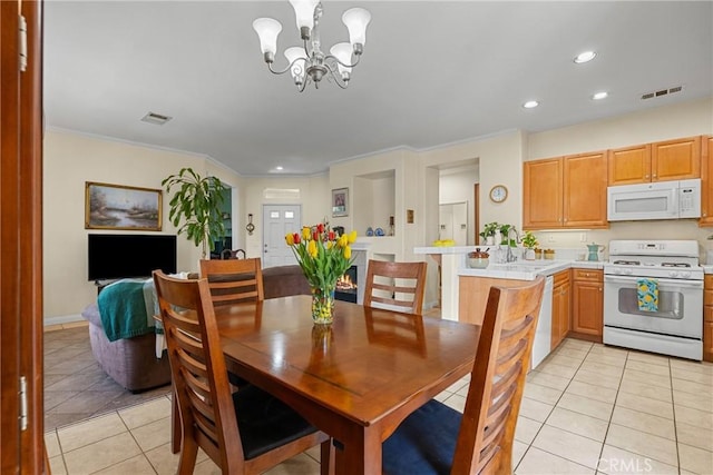 dining space featuring an inviting chandelier, light tile patterned flooring, visible vents, and recessed lighting