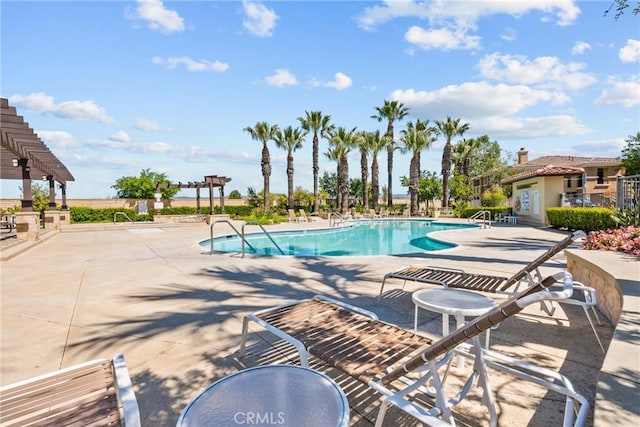 pool featuring a patio and a pergola
