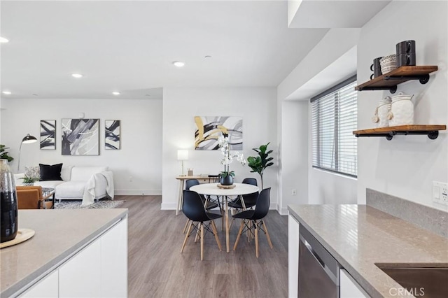 dining room featuring baseboards, recessed lighting, and wood finished floors