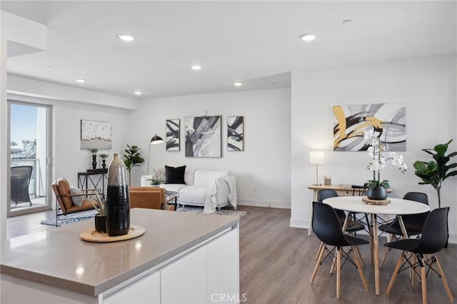 interior space featuring light wood finished floors, recessed lighting, and baseboards