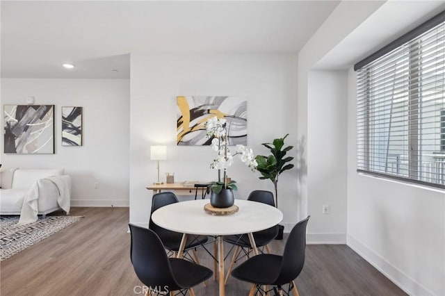 dining area featuring baseboards, recessed lighting, and wood finished floors