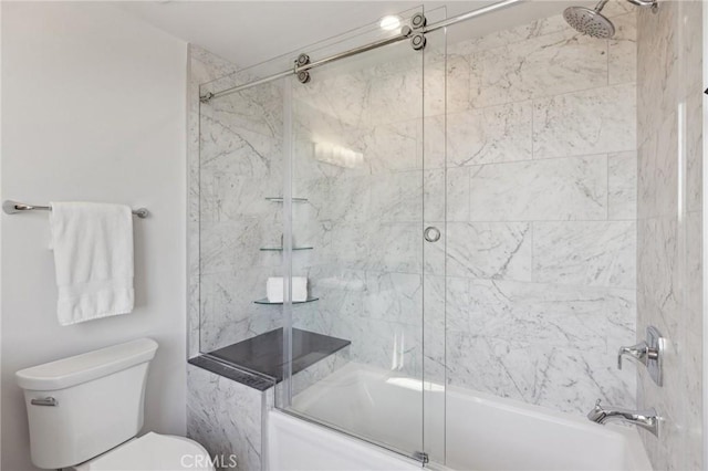 full bath featuring toilet and shower / bath combination with glass door