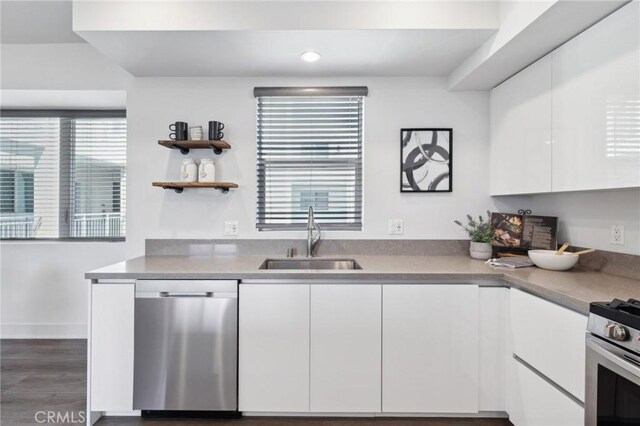 kitchen featuring appliances with stainless steel finishes, white cabinetry, modern cabinets, and a sink