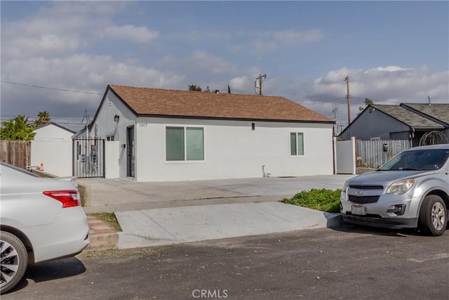 view of front of home featuring fence and stucco siding