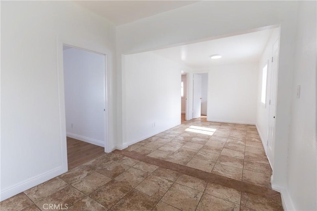 spare room with baseboards