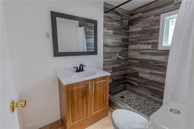 full bathroom with toilet, tile patterned floors, tiled shower, and vanity