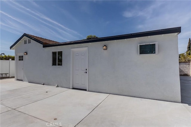 back of property featuring a patio area, stucco siding, and fence