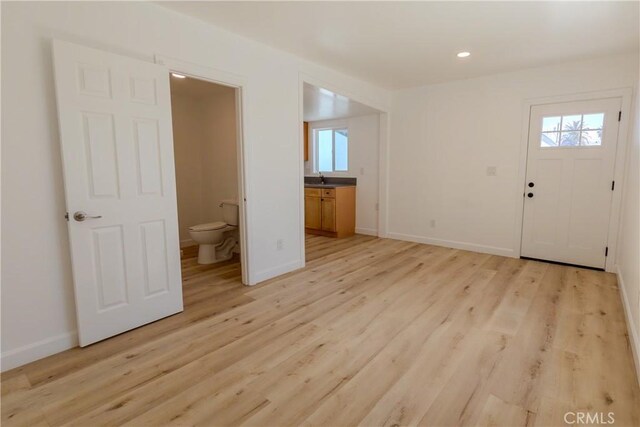 entrance foyer featuring light wood-style floors, baseboards, and recessed lighting