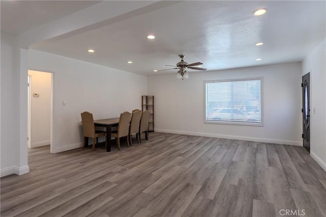 dining room featuring wood finished floors, ceiling fan, baseboards, and recessed lighting