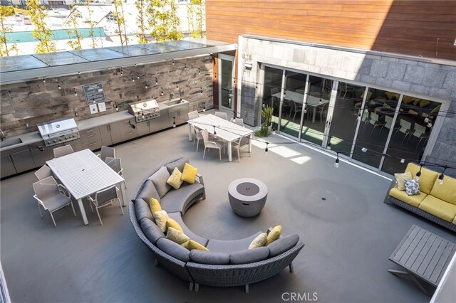 view of patio featuring a grill, outdoor lounge area, an outdoor kitchen, and outdoor dining space