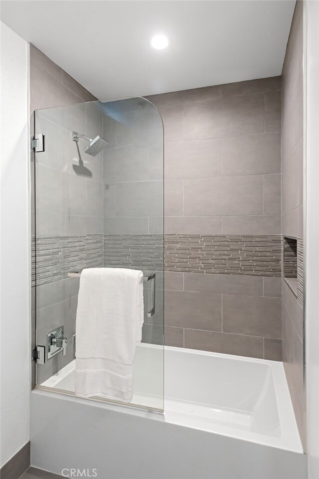 full bath featuring recessed lighting and combined bath / shower with glass door