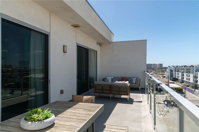 balcony with outdoor lounge area, a city view, and visible vents