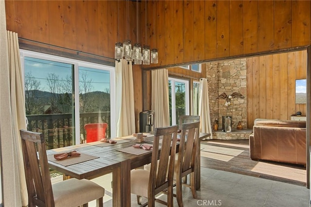 27994 W Shore Rd, Lake Arrowhead, CA 92352 - dining space featuring wooden walls and a stone fireplace