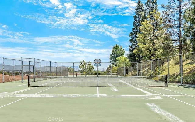 view of tennis court featuring fence