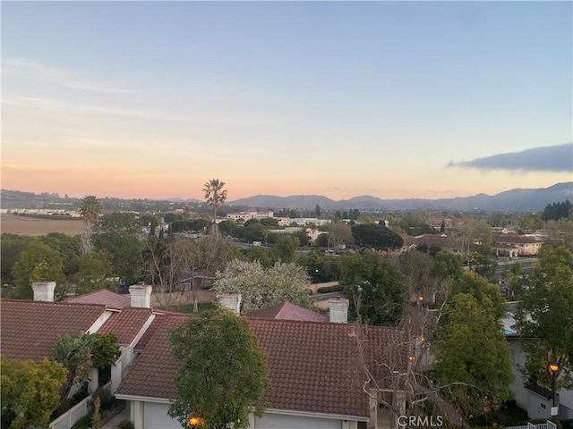 aerial view at dusk featuring a mountain view