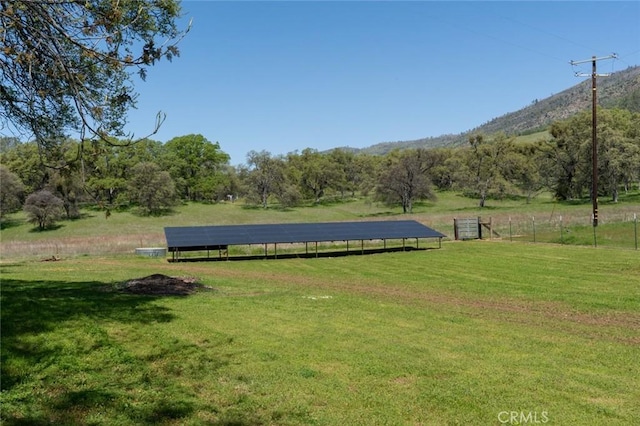 view of community with a lawn and a rural view
