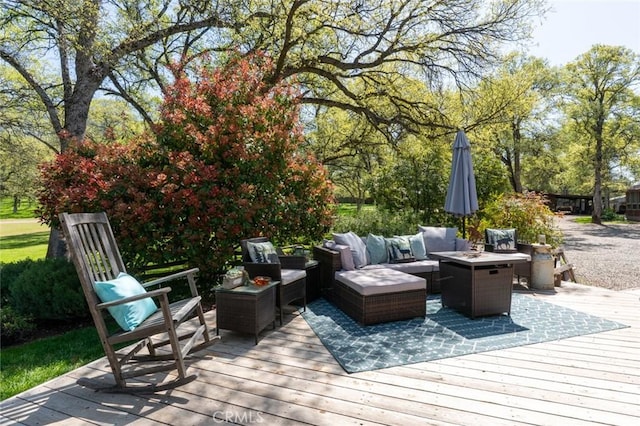 deck with an outdoor living space with a fire pit