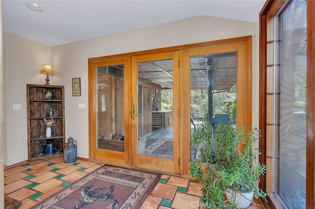 doorway to outside with lofted ceiling