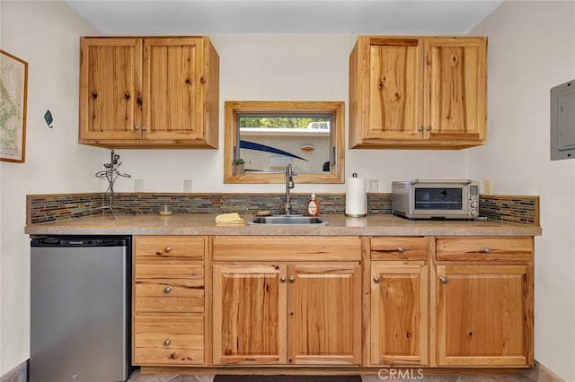 kitchen with electric panel, dishwasher, a sink, a toaster, and freestanding refrigerator