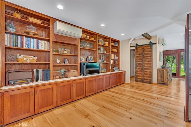 office area with light wood-style floors, a wall mounted air conditioner, recessed lighting, and a barn door