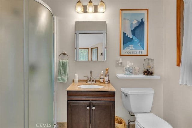 bathroom with vanity, an enclosed shower, and toilet